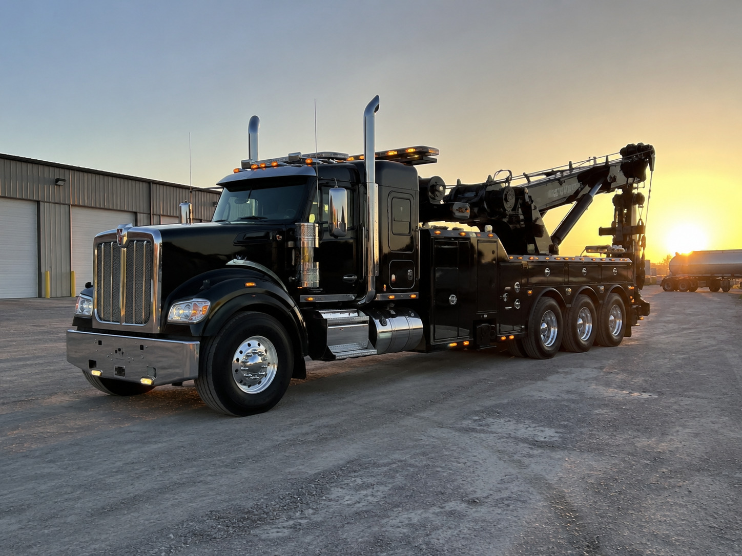 Heavy-duty rotator wrecker at sunset